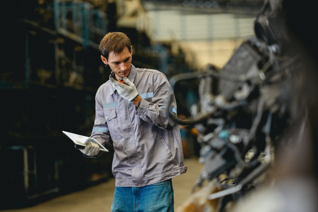 Mechanic inspecting used car: engine, tires, brakes, lights, VIN